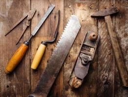 Od vintage hand tools on wooden background. Carpenter workplace photo