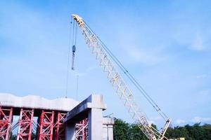 Tower Crane Operating in Construction Site photo