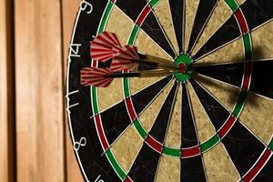 The darts isolated on wooden background