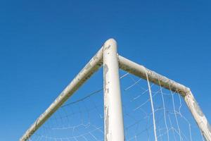 soccer goal in field with blue sky white cloud photo