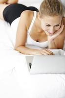 Woman working from her bed photo