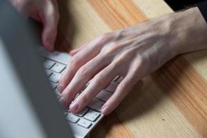 close up of typing man hands photo