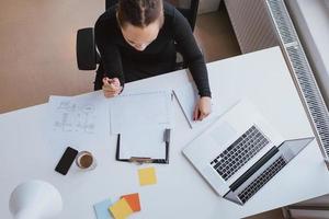 Businesswoman analyzing financial data at a white desk photo