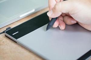 Man uses graphics tablet. photo