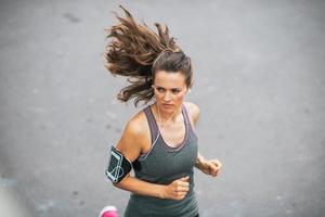 fitness young woman jogging outdoors in the city photo