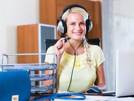 Woman with headset working at laptop