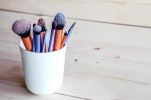 Make up tools on a wooden background photo