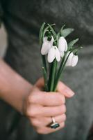 Girl holding snowdrops bouquet