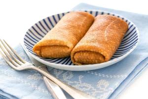 Crepes stuffed with cottage cheese. photo