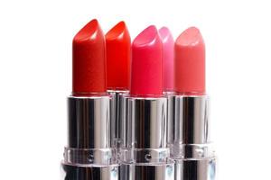 Five lipsticks on white photo