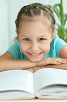 Beautiful little girl with book photo