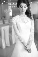 Beautiful young caucasian bride in fashionable wedding dress. photo