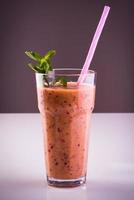 Glass of banana with blackberry smoothie photo