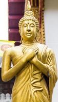 Standing Thai Golden Buddha statue photo