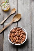 close-up almond nuts on wood background photo
