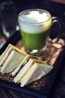 Matcha green tea latte on wooden table photo