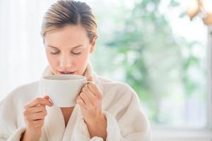 Beautiful Woman Drinking Coffee In Health Spa photo