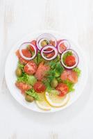fresh salad with salted salmon, top view, vertical