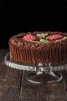 Kiev cake with chocolate cream on the glass stand vertical photo