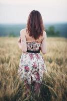 Beautiful young woman in a wheat field photo