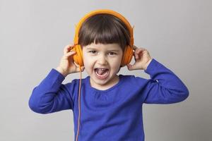 happy 4-year old preschool girl enjoying a groovy stereo
