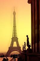 Eiffel Tower and silhouettes of sculptures. View from  Trocadero. Sanset.