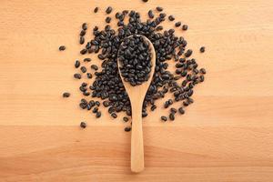 Black beans with wooden spoon