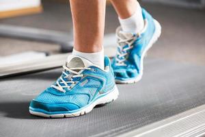 Woman running on treadmill in gym. photo