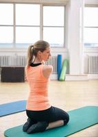 Woman doing stretching exercises at gym photo