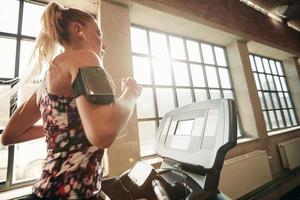 Female working out on a treadmill at gym photo