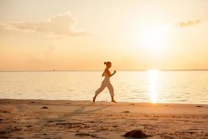 Caucasian woman jogging at seashore photo