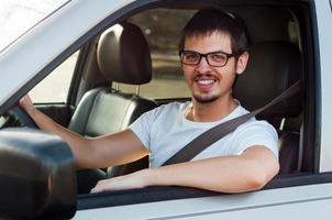 Male caucasian good driver is smiling in his car photo