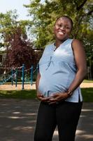 Happy Pregnant Mother at the park photo