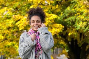 Beautiful african american woman smiling in autumn photo