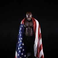 Male athlete carrying an American flag photo