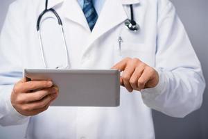 Male doctor with tablet computer photo