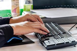 Hand typing on computer keyboard. photo