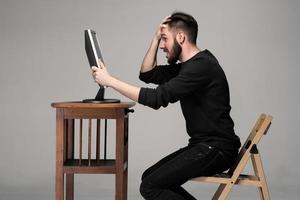 Funny and crazy man using a computer photo