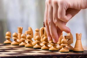 hand of chess player with pawn photo