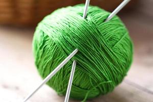 Clew of yarn with needles for knitting photo