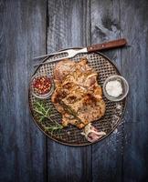 roast pork garlic, salt red sauce iron tray rustic wooden photo