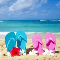 Flip flops on sandy beach photo
