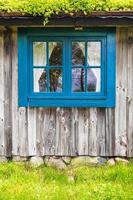 Ancient Swedish wooden farmhouse with blue window