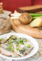 Pickled herring with green green onions and fennel. photo