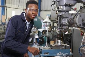 Male Apprentice Engineer Working On Drill In Factory photo
