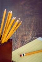Group of yellow pencils in pencil holder photo