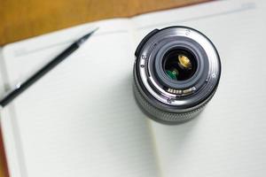 Camera photo lens on notebook ,concept photography