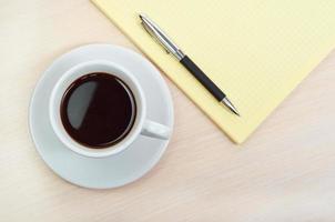 Coffee cup with note book photo