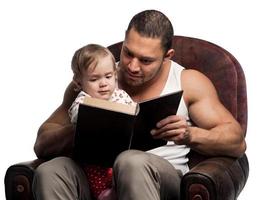 Father reading book to daughter photo