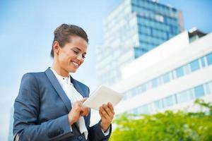 business woman with tablet pc in office district photo